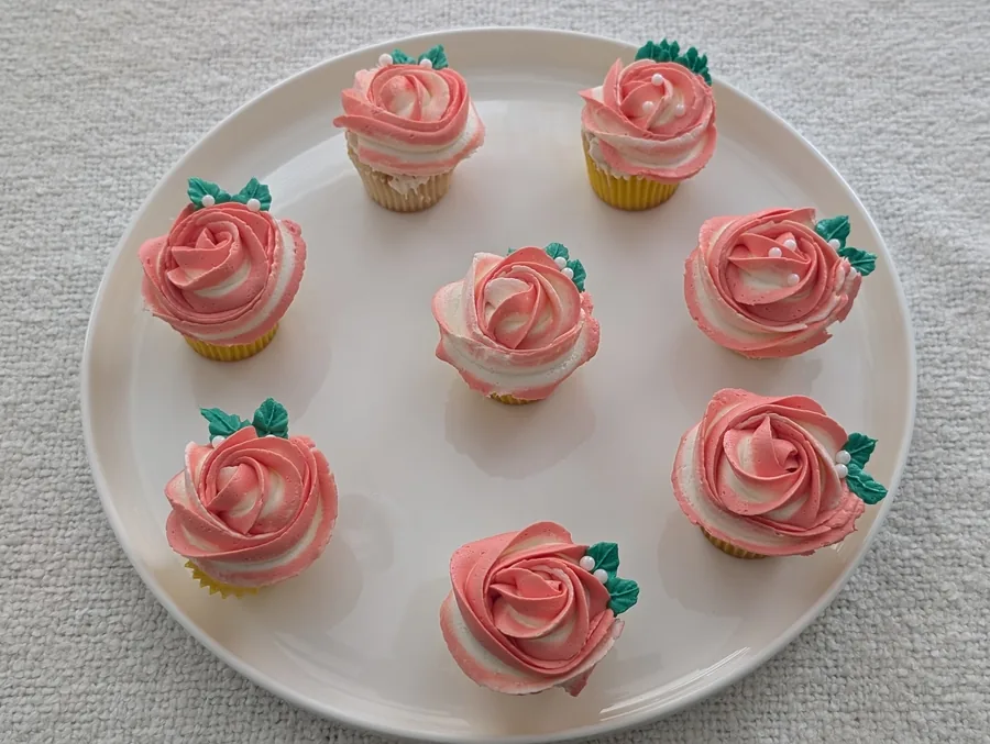 Lemon and blueberry cupcakes topped with bright frosting