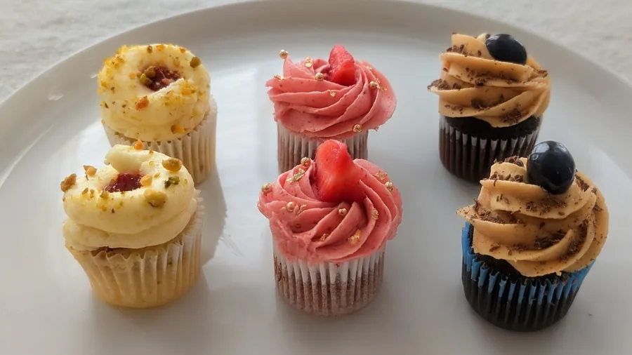 Cupcakes decorated with pink rose-shaped frosting