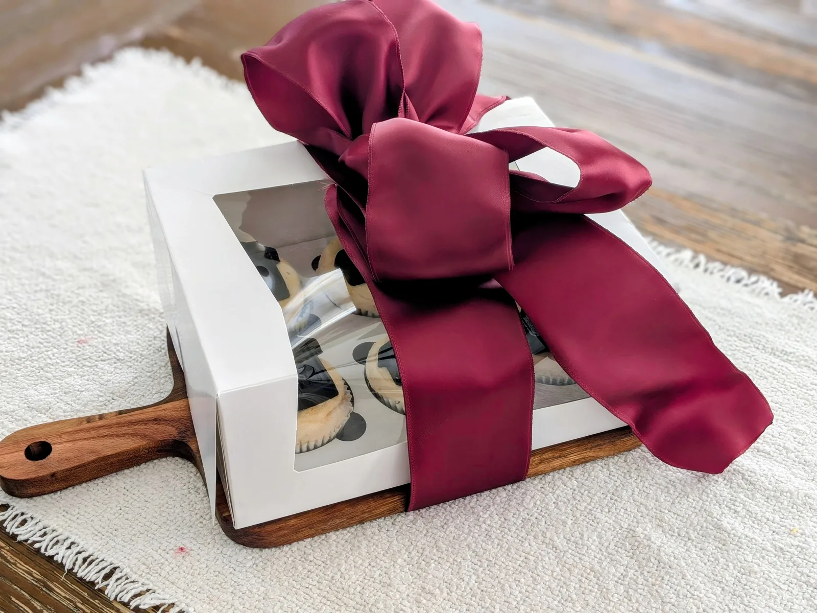 A housewarming gift featuring an engraved board and baked goods